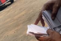 TERPANTAU: oknum calo saat bagi-bagi uang pengkondisian berbentuk amplop. (Foto: news.devilo.co).